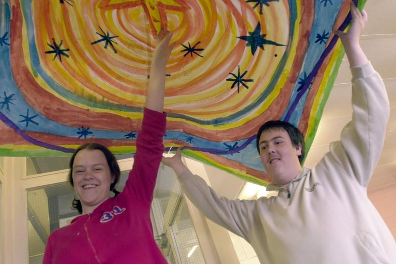 Arts project pupils Jenny Hogg and Ryan Landreth create window art at Intake High School in June 2001.