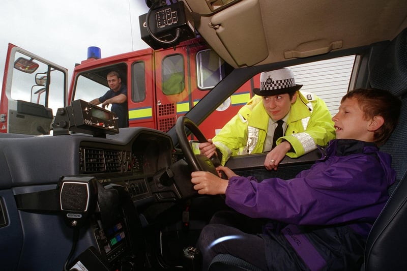 Leeds Driving Instructors Association held a road safety family day event at Elland Road. Pictured is Ryan Carter behind the wheel of one of the police's traffic patrol cars, watched by PC Ann Drury.