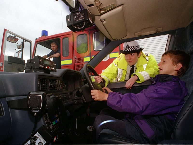 Leeds Driving Instructors Association held a road safety family day event at Elland Road. Pictured is Ryan Carter behind the wheel of one of the police's traffic patrol cars, watched by PC Ann Drury.