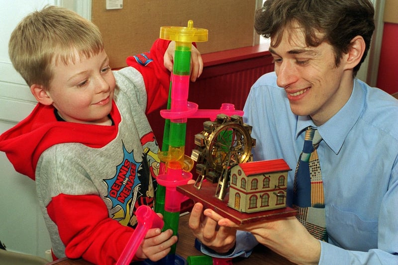 A toy wonder weekend was held at Dewsbury Museum in March 1997. Pictured is museum officer Richard Butterfield showing a antique model mechanical fairground wheel to young Edmund Pollard.