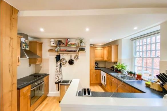 The kitchen is a narrow but cleverly designed space, with plenty of counter room for cooking, as well as integrated appliances, including space for a washing machine.
