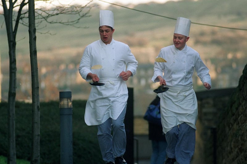 Catering students Matthew Lumb (left) and Jon Green prepare for the charity Pancake Race held at Dewsbury College in February 1997.