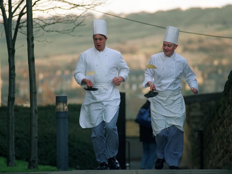 Catering students Matthew Lumb (left) and Jon Green prepare for the charity Pancake Race held at Dewsbury College in February 1997.