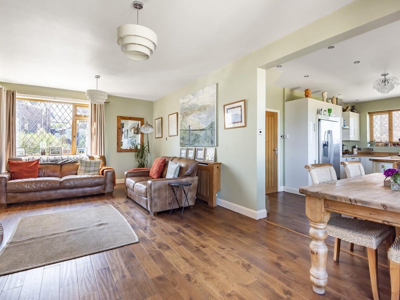 The home interior with lounge and dining space linked to the kitchen area