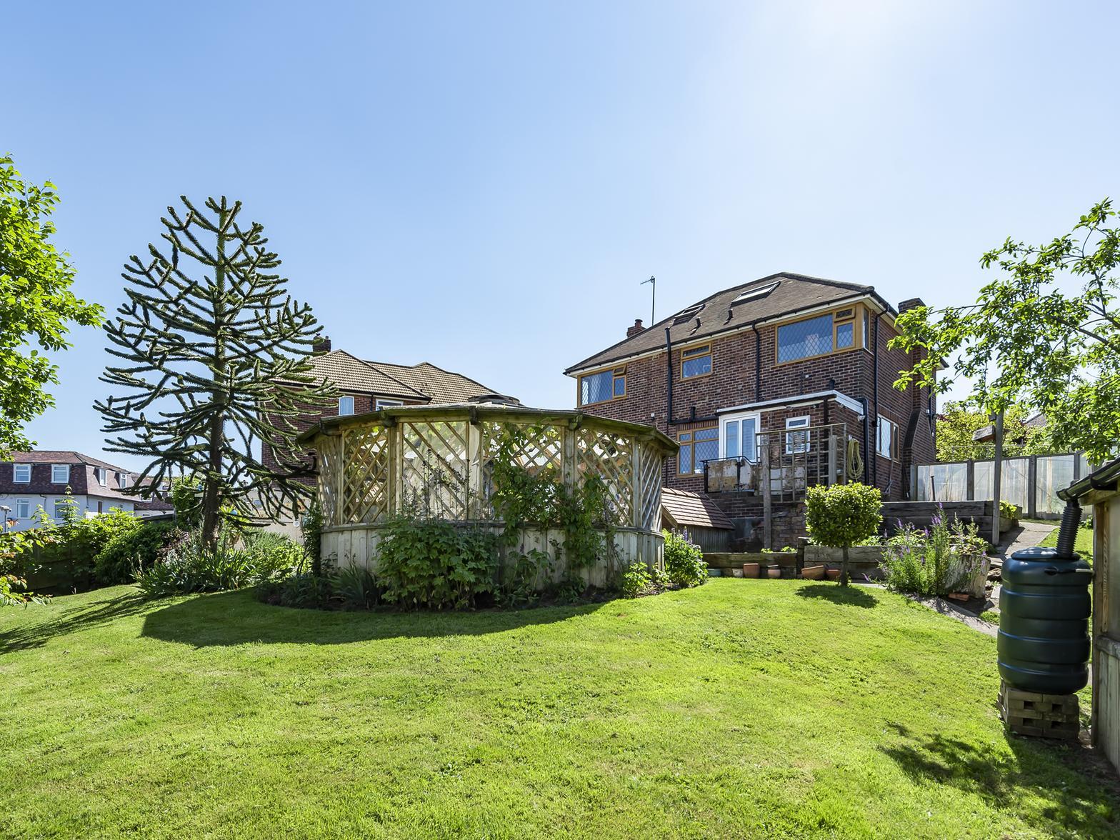 Looking up at the property towards the sun room,  from the rear garden