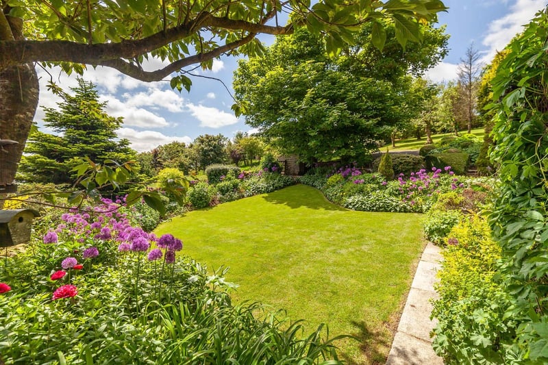 Lawns, trees, bushes, plants and shrubs all feature in the extensive gardens