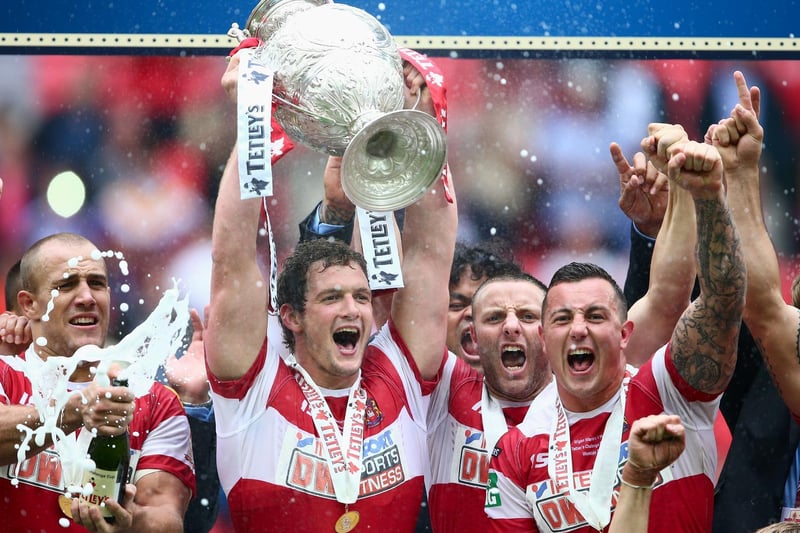 2013 - Sean O'Loughlin of Wigan Warriors lifts the trophy after Wigan Warriors won the Tetley's Challenge Cup Final between Wigan Warriors and Hull FC at Wembley Stadium on August 24, 2013.