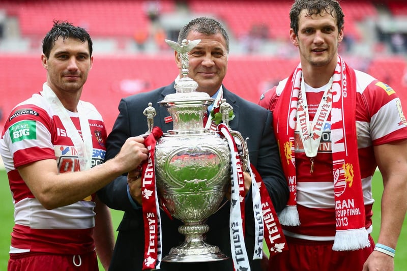 2013 -  Wigan Warriors coach Shaun Wane poses with the trophy alongside Sean O'Loughlin (R) and Matthew Smith (L) of Wigan Warriors after Wigan Warriors won the Tetley's Challenge Cup Final between Wigan Warriors and Hull FC at Wembley Stadium.