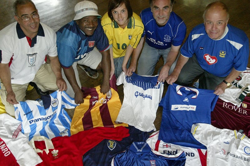 Representatives from the St Augustines Centre receive donated football shirts from the Trades Club, Hebden Bridge.