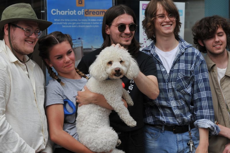 Wigan band The Lathams (pictured posing for photos with a fan and her dog!)