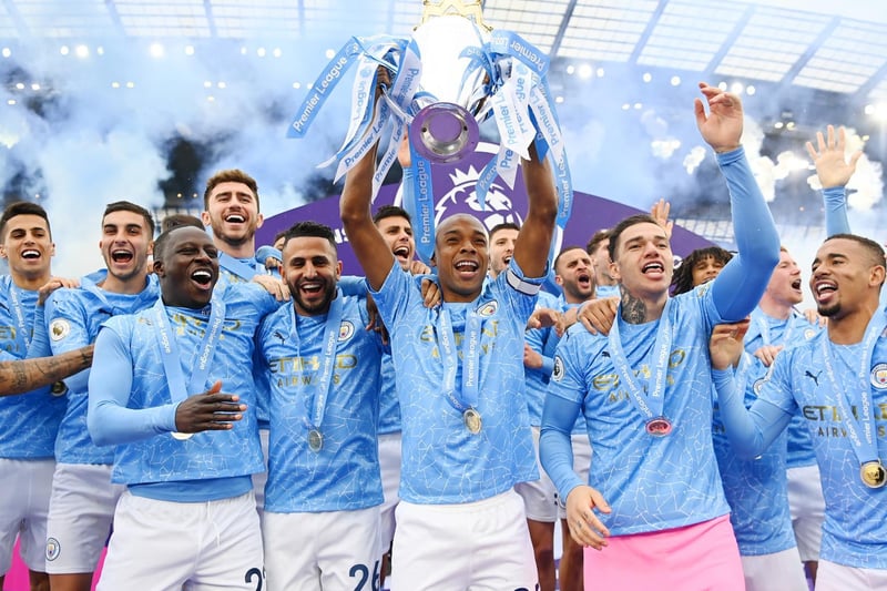 Fernandinho of Manchester City lifts the Premier League Trophy with team mates Benjamin Mendy, Riyad Mahrez, Ederson and Sergio Aguero at the Etihad Stadium on May 23, 2021 in Manchester, England.