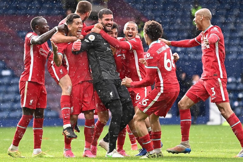 Alisson Becker of Liverpool is congratulated by Sadio Mane, Roberto Firmino, Thiago Alcantara, Trent Alexander-Arnold and Fabinho after scoring the winning goal during the Premier League match against West Bromwich Albion at The Hawthorns on May 16, 2021 in West Bromwich, England.