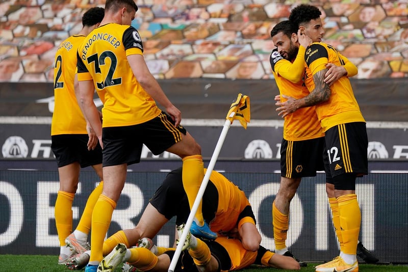 Morgan Gibbs-White of Wolverhampton Wanderers (hidden) celebrates after scoring their sides second goal with team mates during the Premier League match between Wolverhampton Wanderers and Brighton & Hove Albion at Molineux on May 09, 2021 in Wolverhampton, England.