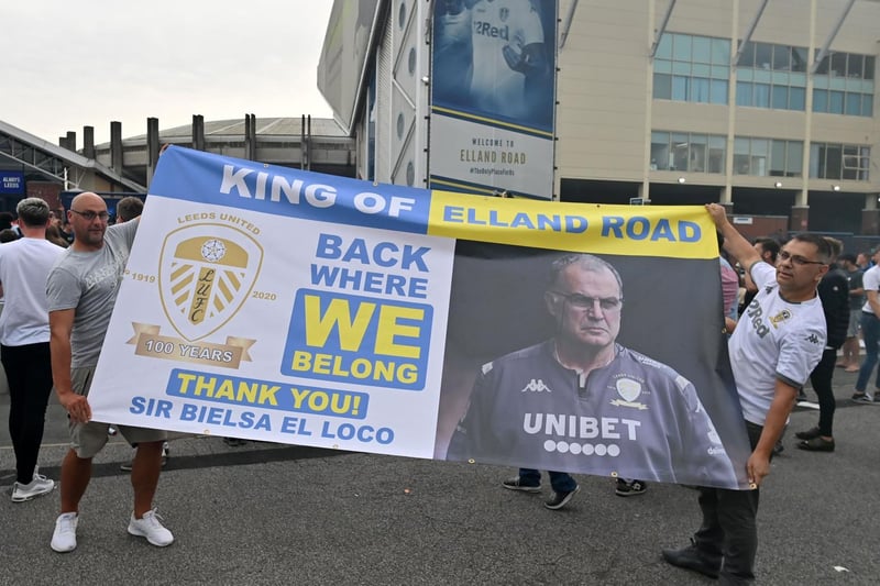 Supporters hold up a large banner as they gather outside Elland Road to celebrate promotion.