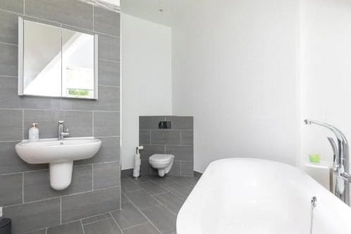 Four-piece suite comprising; - low flush WC, bath, centre wash basin and shower cubicle.