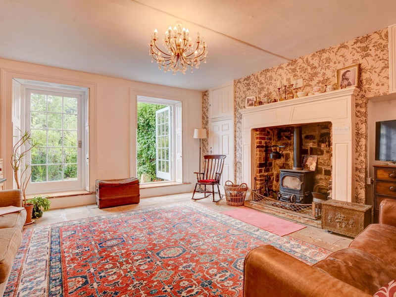 A grand fireplace and large, Georgian style windows that flood rooms with natural light
