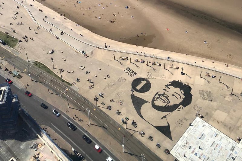 Today (Tuesday, July 20), Jordan has arranged for a GIANT picture of his own face to be printed on the pavement of the Promenade - seen here from the top of Blackpool Tower. Pic: Jordan North/BBC