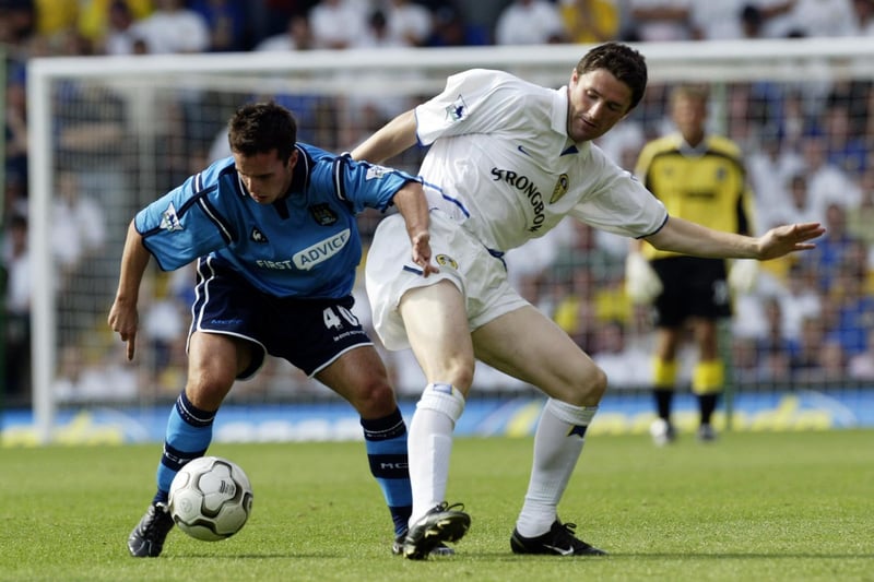 Robbie Keane tackles Manchester City's Chris Shuker.