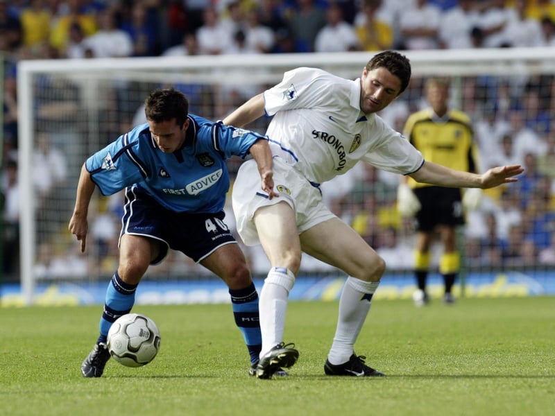 Robbie Keane tackles Manchester City's Chris Shuker.