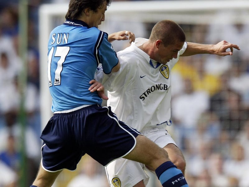Harry Kewell holds off Manchester City's Jihai Sun.