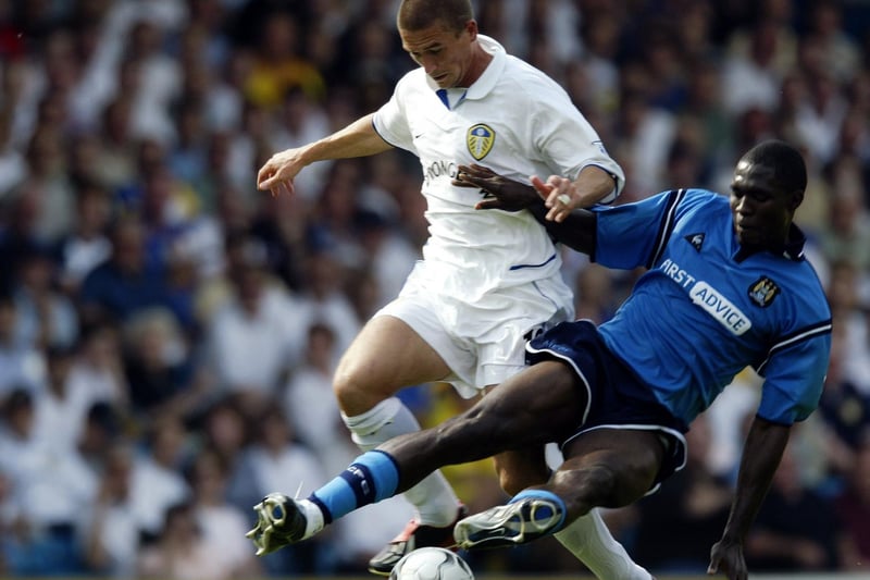 Harry Kewell holds off a challenge from Manchester City's Marc-Vivien Foé.