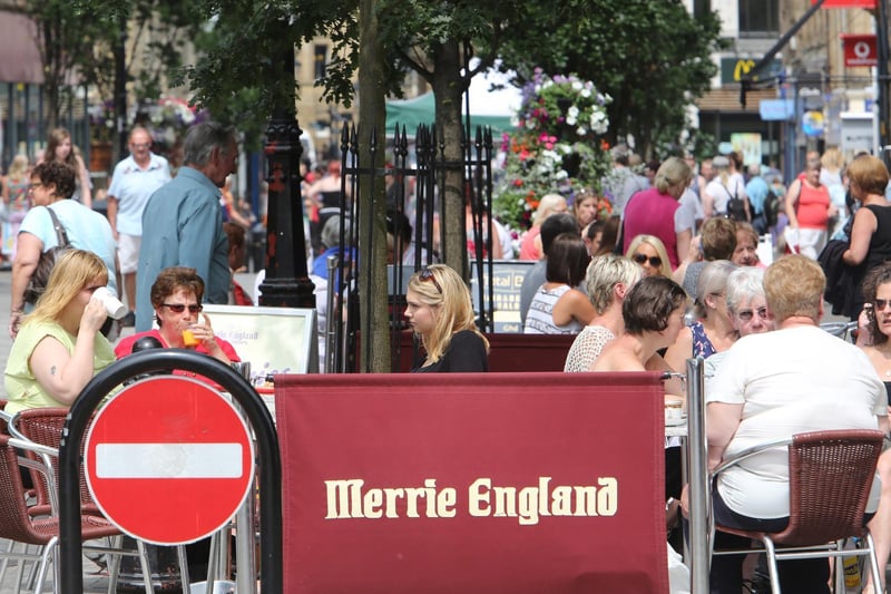 People sat out in the sunshine at Merrie England in 2013
