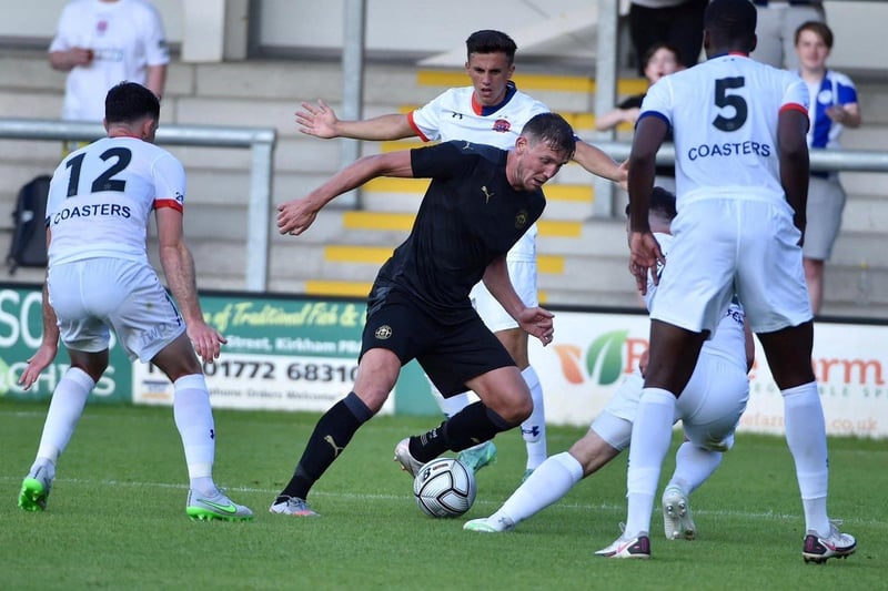 Charlie Wyke is surrounded by AFC Fylde players inside the penalty area