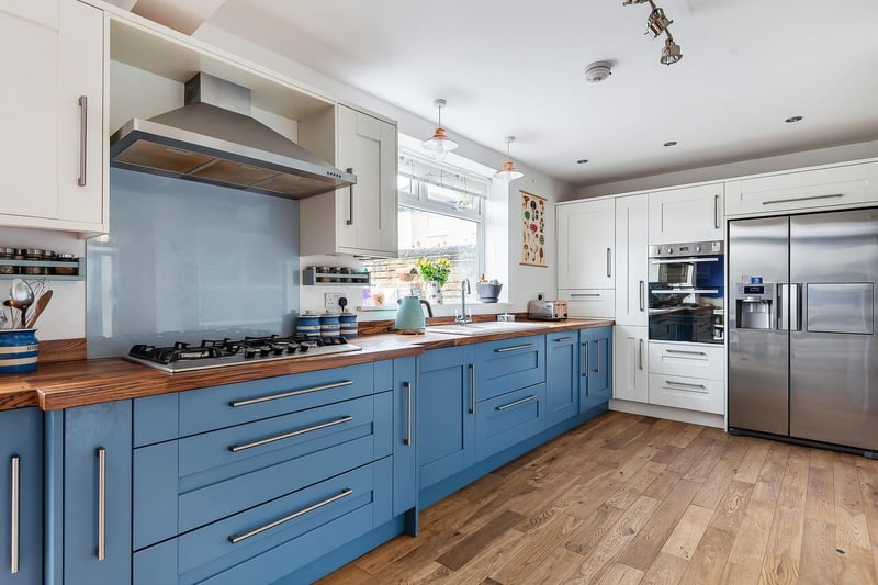 Enter through the light and airy hallway which leads through into the open plan, extended kitchen and dining area. The kitchen is fully fitted super modern kitchen with ample wall & base space for a large fridge freezer and high spec work tops and flooring.