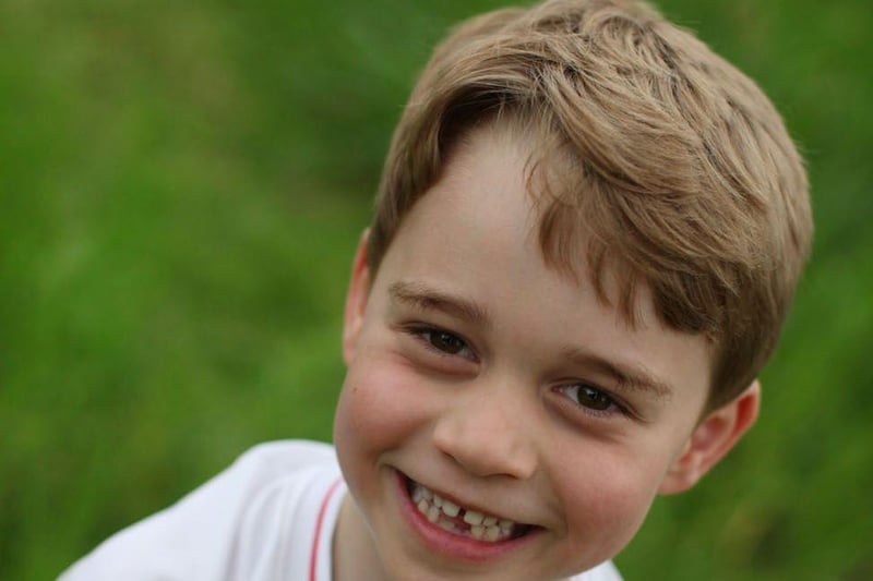 Prince George is seen smiling in an England football shirt for official photographs released to mark his sixth birthday in 2019.