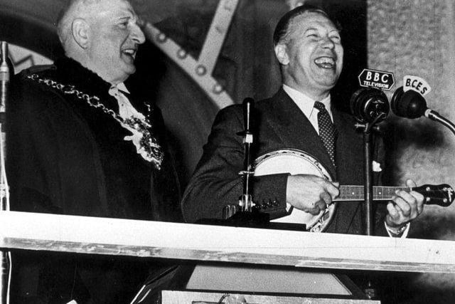 Entertainer George Formby takes his turn to switch on the 1953 lights