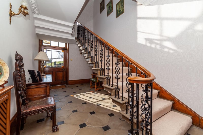 A feature staircase leads up from this entrance hall