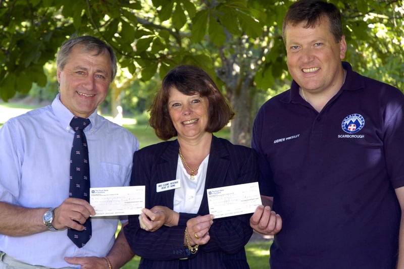 Elaine Heritage, of George Edward Smart Homes, presents cheques to Fred Normandale, RNLI, and Andrew Priestley, Scarborough and District Search and Rescue.