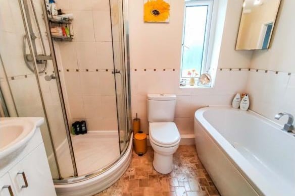 The family bathroom is a good size and modern. It is part tiled and features a walk in shower and bath.
