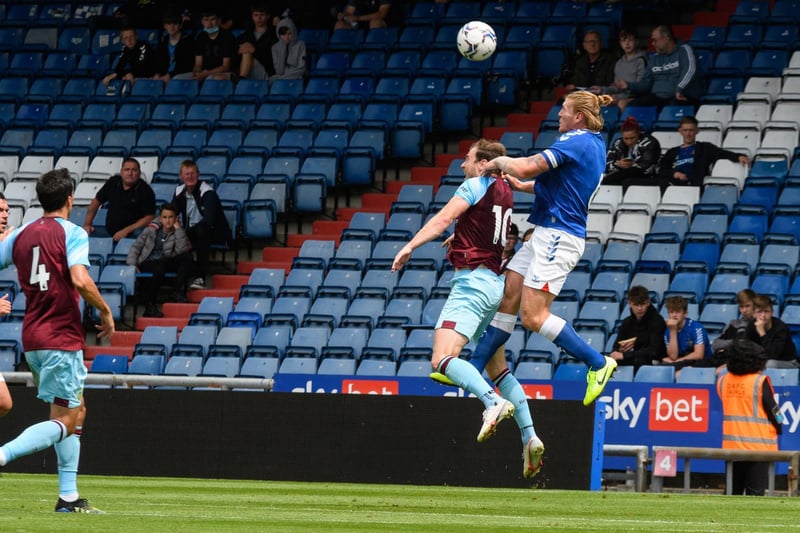 Ashley Barnes looks to win a header in the Oldham box