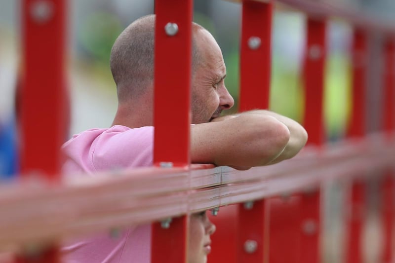 A PNE fan leans on the gate at Accrington