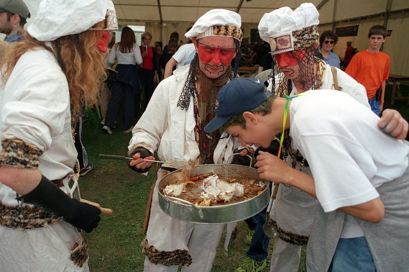 The Nomadic Chefs try to tempt a reveller into a taste of their dish.