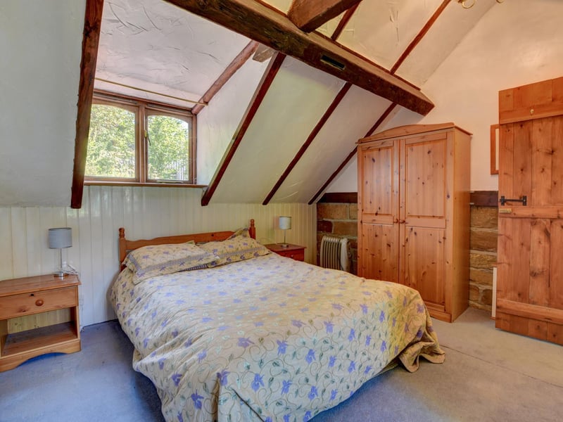 One of the farmhouse bedrooms,  with sloping roof