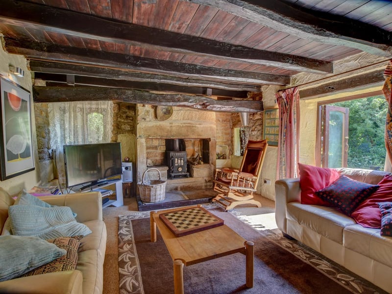 Beams and double doors that lead outside, from this snug lounge