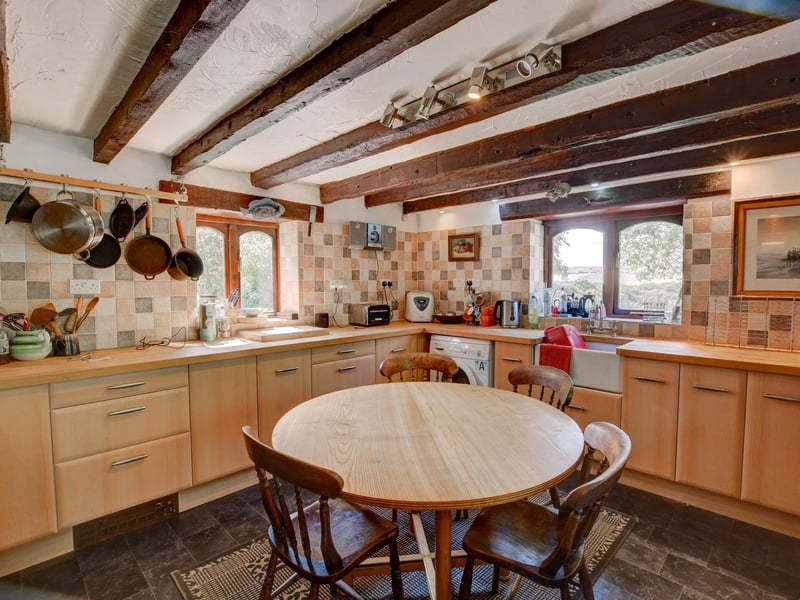 Plenty of space, storage and light within this beamed farmhouse kitchen