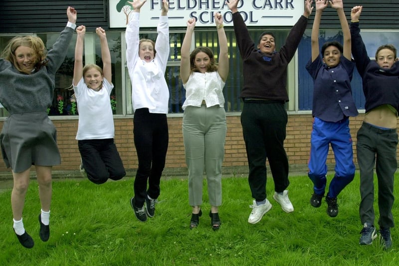 Pupils from class 6H at Fieldhead Carr Primary in Whinmoor celebrate their SAT results with teacher Sarah Harman (centre).
