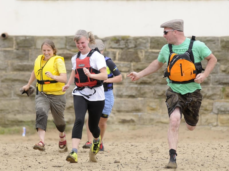 Team-mates make a dash for their raft.