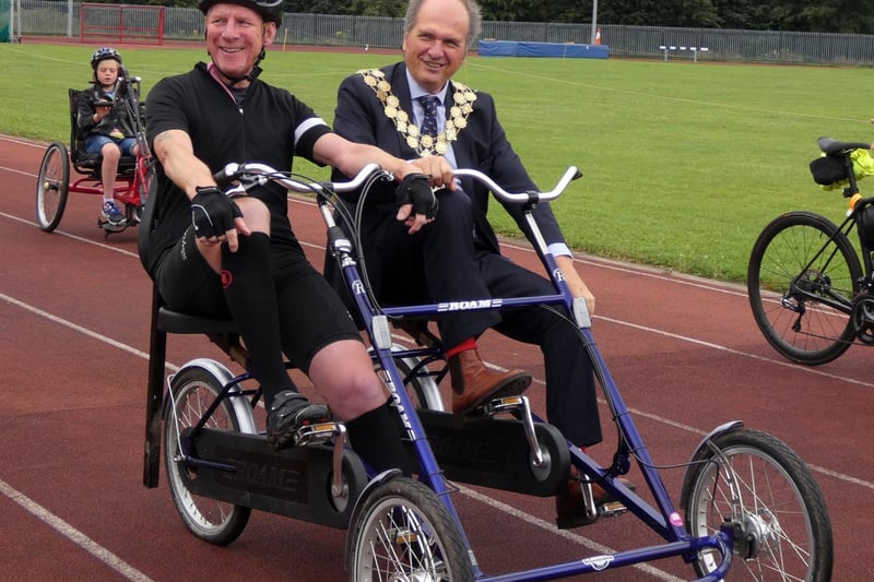 Mayor of Kirklees Coun Nigel Patrick getting a bike-riding experience with cyclist  Martyn Bolt before the start of the Jo Cox Way bike ride. Photo: Anthony Hayward/Profiles International Media