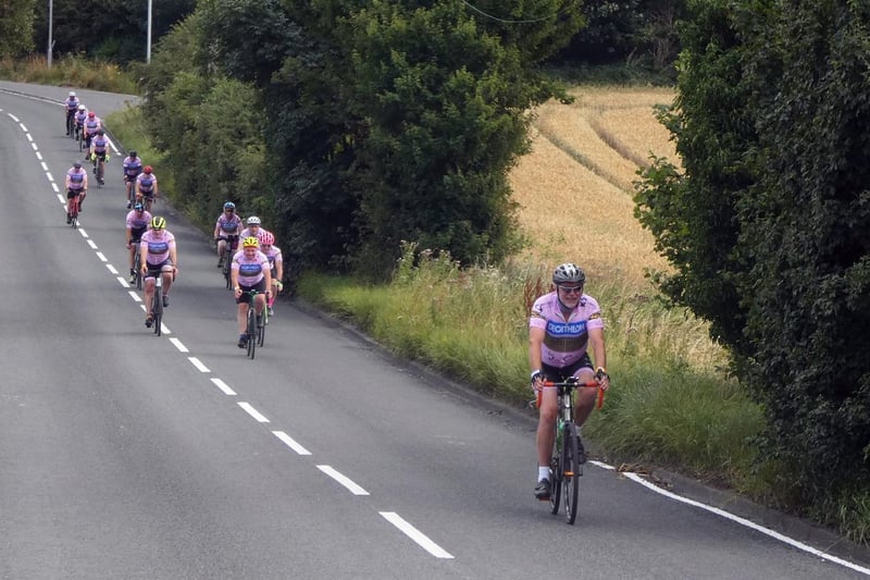 The cyclists passing through Horbury Bridge on the early part of their route. Photo: Anthony Hayward/Profiles International Media