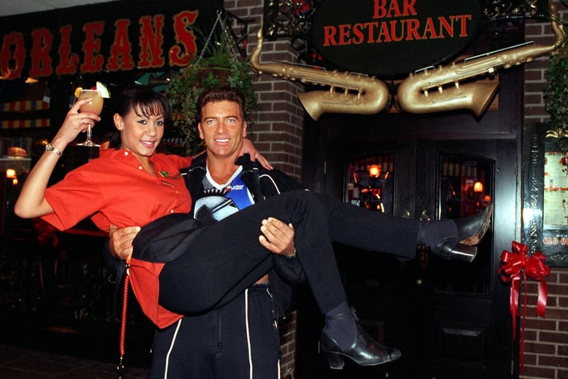 TV's Gladiator Warrior opened the Old Orleans restaurant on Boar Lane. He is  pictured lifting waitress Lyndsay Hamilton of her feet.