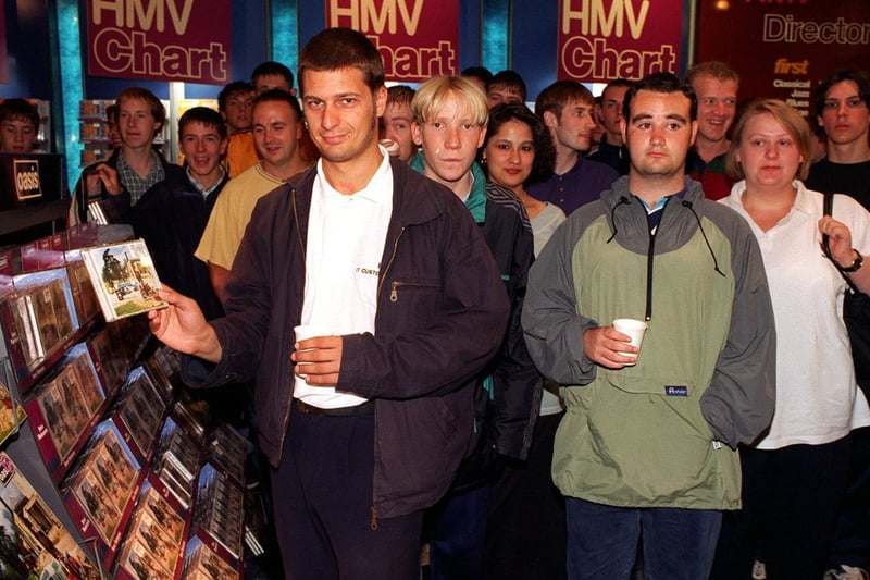 Oasis fans wait to buy the band's new album Be Here Now at HMV in Leeds city centre.