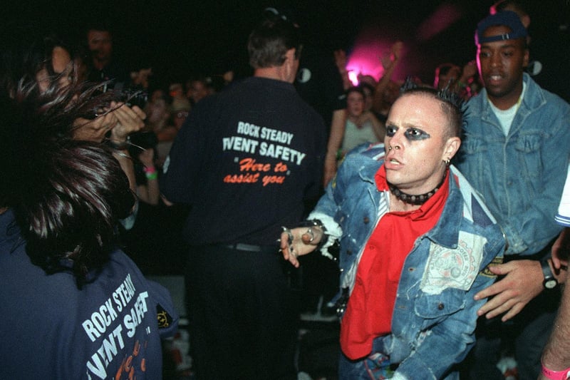 Keith Flint of The Prodigy makes his way back to the stage after climbing down to be with the crowd at the V97 festival held at Temple Newsam.
