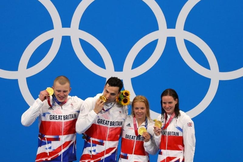 Left to right: Gold medalists Kathleen Dawson, Adam Peaty, James Guy and Anna Hopkin of Team Great Britain pose after the medal ceremony for the Mixed 4 x 100m Medley Relay Final at Tokyo Aquatics Centre