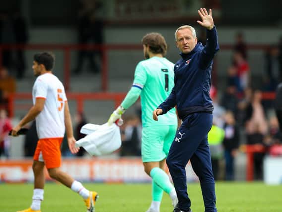 Neil Critchley waves to the Blackpool fans at the full-time whistle