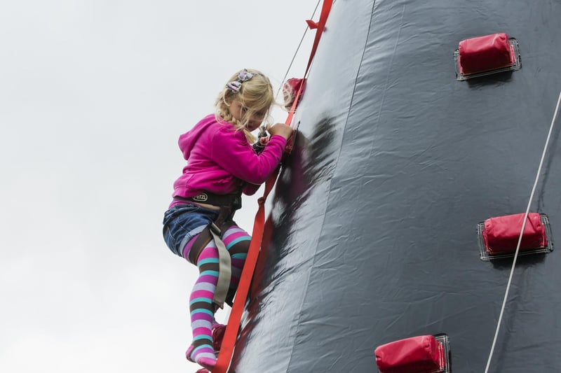 Gabbie Payne, five, has a go on the climbing wall.