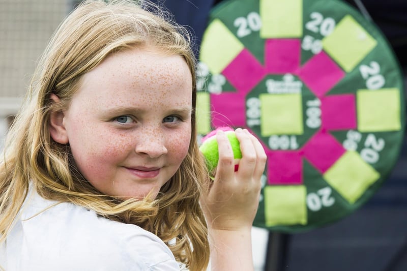 Scarlett Kinsey, 10, tries to hit the target on the Elland Children's Centre stall.
